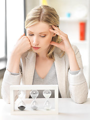 Image showing pensive businesswoman with sand glass