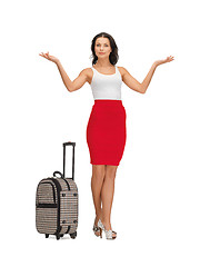 Image showing happy woman with suitcase greeting