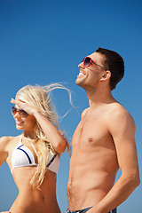 Image showing happy couple in sunglasses on the beach