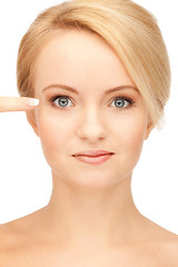 Image showing beautiful woman pointing to eye