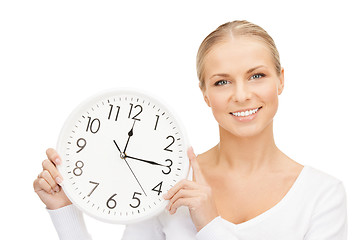 Image showing woman holding big clock