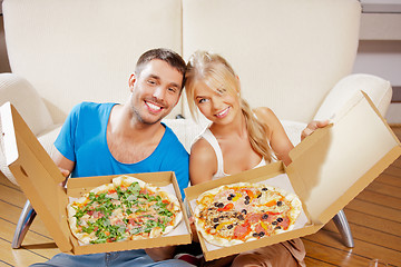 Image showing romantic couple eating pizza at home