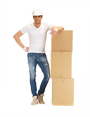 Image showing handsome builder with big boxes