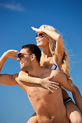 Image showing happy couple in sunglasses on the beach