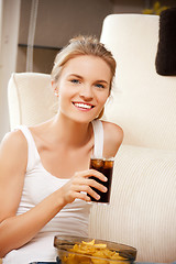 Image showing smiling teenage girl with chips and coke