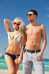 Image showing happy couple in sunglasses on the beach