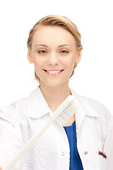 Image showing attractive female doctor with toothbrush