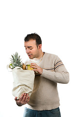 Image showing Man Looking Inside His Grocery Bag