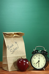 Image showing School Lunch, Apple and Clock on Desk at School