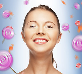 Image showing happy teenage girl with lollipops