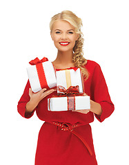Image showing lovely woman in red dress with gift boxes