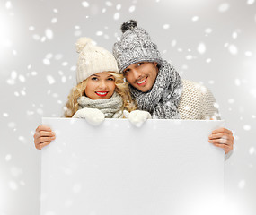 Image showing couple in a winter clothes holding blank board