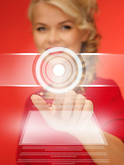 Image showing woman in red dress pressing virtual button