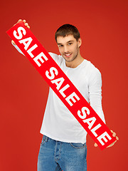 Image showing handsome man with sale sign