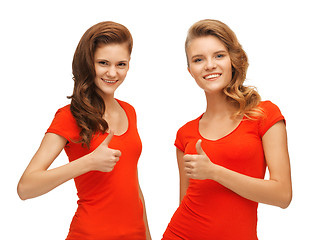 Image showing wo teenage girls in red t-shirts showing thumbs up