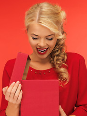 Image showing lovely woman in red dress with opened gift box