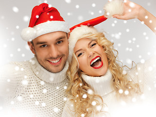 Image showing family couple in sweaters and santa's hats