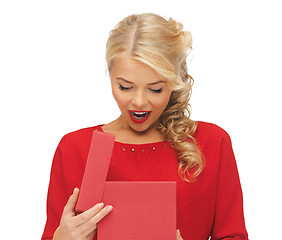 Image showing lovely woman in red dress with opened gift box