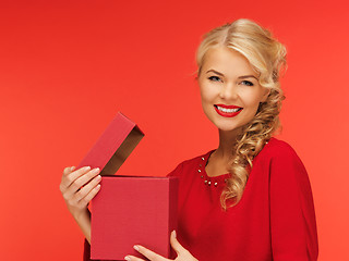 Image showing lovely woman in red dress with opened gift box