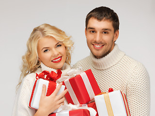 Image showing family couple in a sweaters with gift boxes