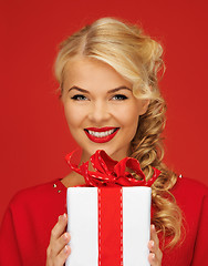 Image showing lovely woman in red dress with present