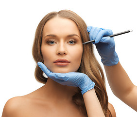 Image showing woman face and beautician hands