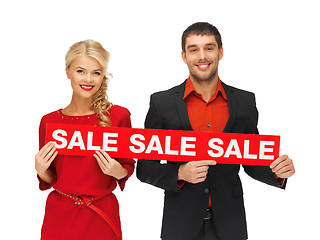 Image showing man and woman with sale sign