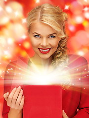 Image showing lovely woman in red dress with opened gift box