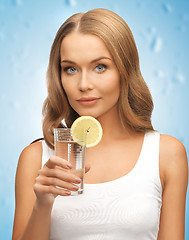 Image showing woman with lemon slice on glass of water