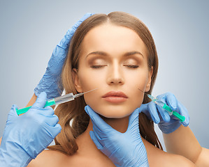 Image showing woman face and beautician hands