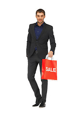 Image showing handsome man in suit with sale sign