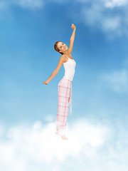 Image showing woman in pajamas doing morning exercise