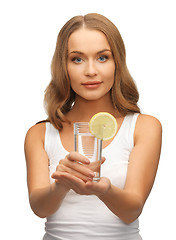 Image showing woman with lemon slice on glass of water