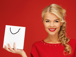 Image showing lovely woman in red dress with shopping bag