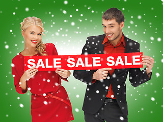 Image showing man and woman with sale sign