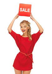 Image showing lovely woman in red dress with sale sign