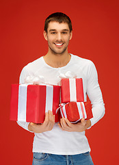 Image showing man holding many gift boxes