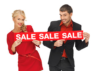 Image showing man and woman with sale sign