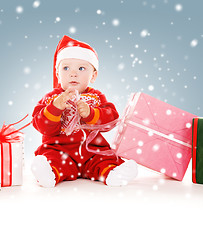 Image showing santa helper baby with christmas gifts