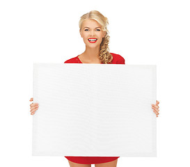 Image showing lovely woman in red dress with blank board