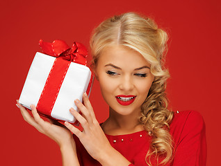 Image showing lovely woman in red dress with present