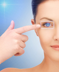 Image showing beautiful woman pointing to eye