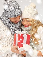 Image showing romantic couple in a sweaters with gift box