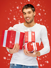 Image showing man holding many gift boxes