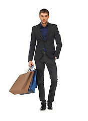 Image showing handsome man in suit with shopping bags