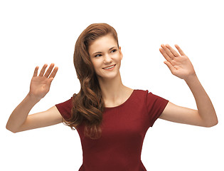 Image showing girl in red dress working with something imaginary