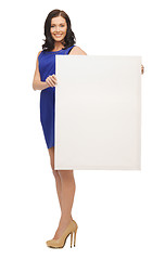 Image showing lovely woman in blue dress with blank board