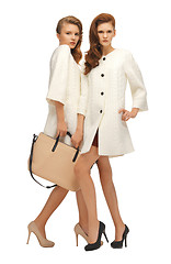 Image showing two teenage girls in white coats with bag