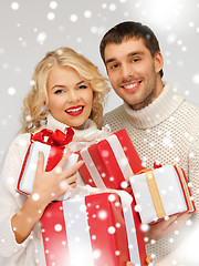 Image showing family couple in a sweaters with gift boxes