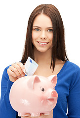 Image showing lovely woman with piggy bank and money